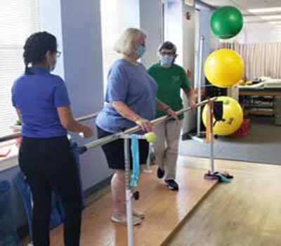 Jane helping physical therapy patients at La Plata Physical Therapy in La Plata, MD