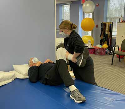 Jennifer working with a patient's leg at La Plata Physical Therapy in La Plata, MD