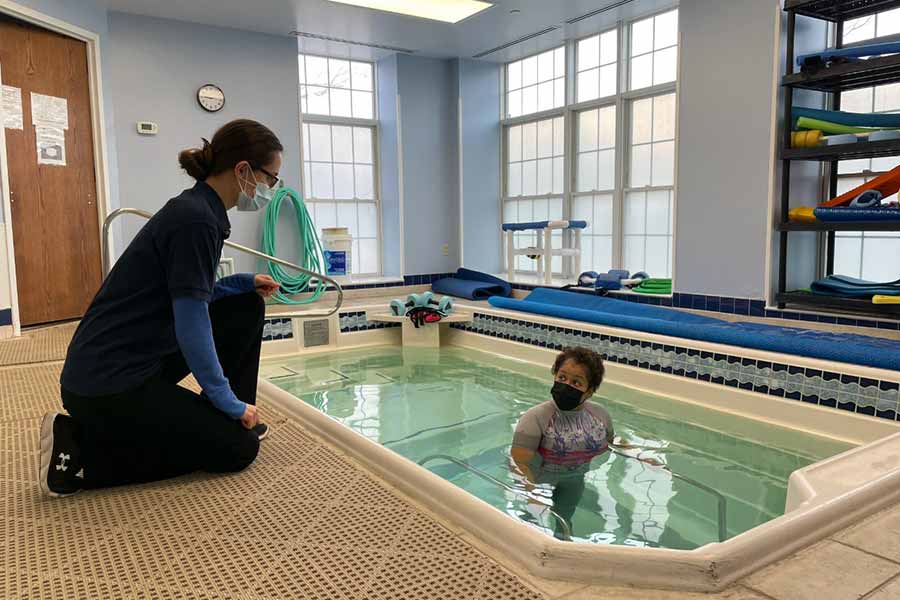 Physical therapy assistant teaching a patient about aquatic therapy at La Plata Physical Therapy and Wellness in La Plata, MD