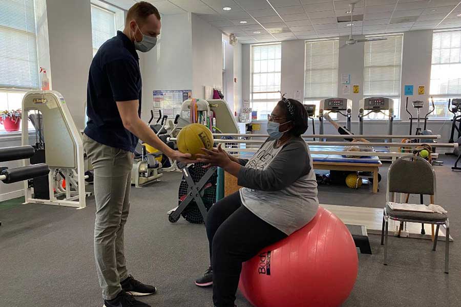 Ben working with a patient on an exercise ball at La Plata Physical Therapy in La Plata, MD